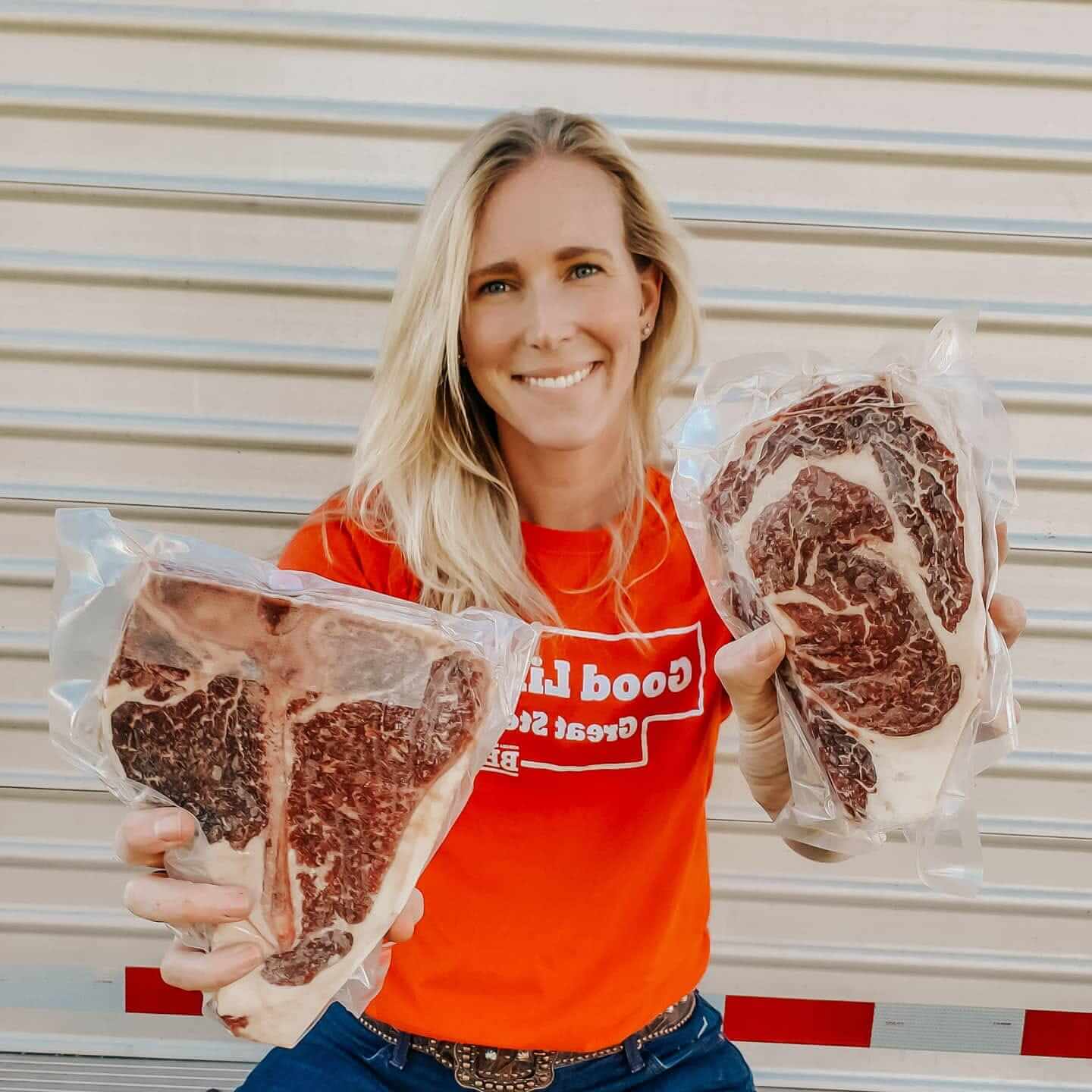D & D Beef Owner holding up raw packaged beef steaks